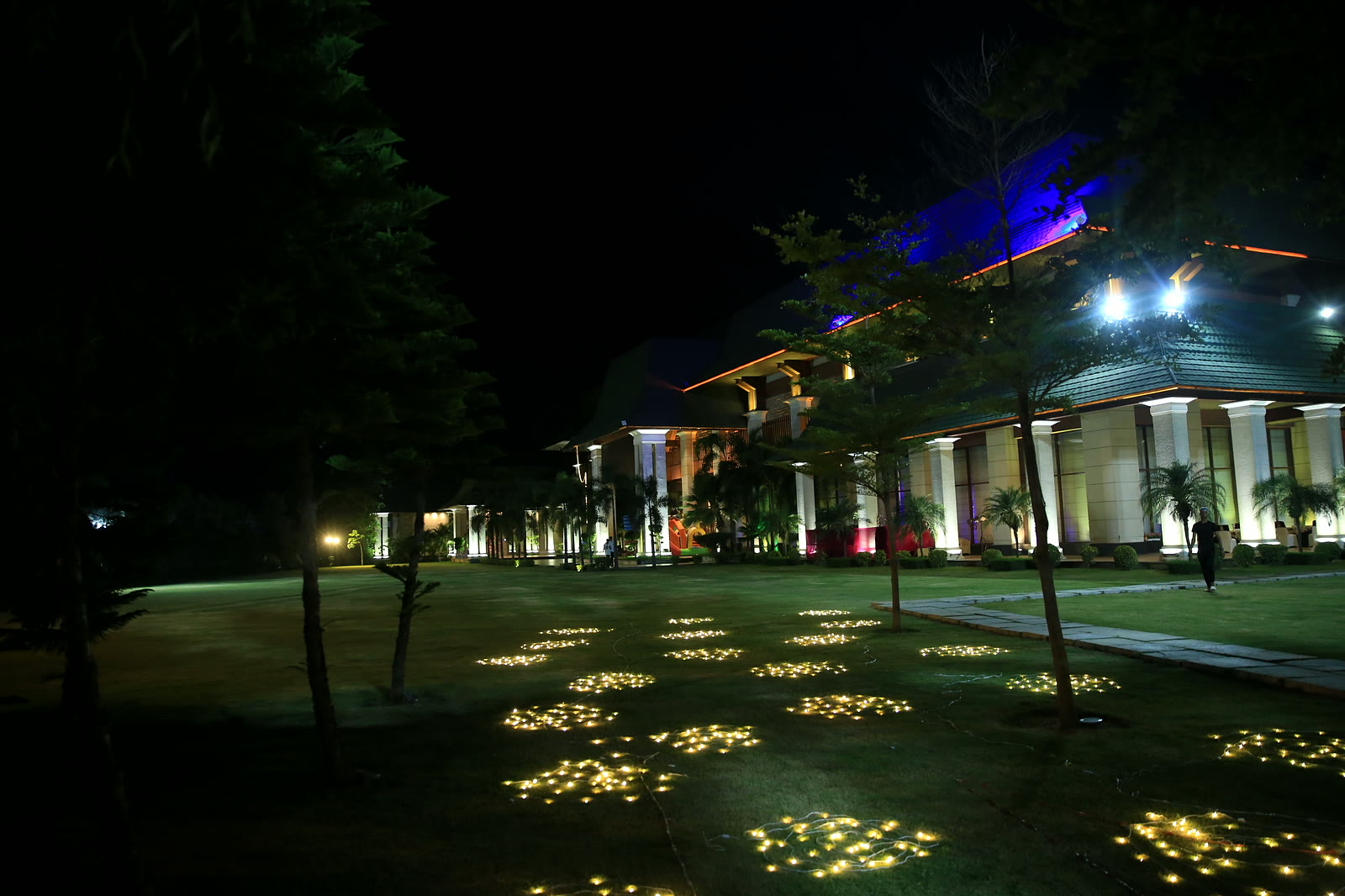 Majestic Grand at night, the lawn scattered with pools of fairy lights